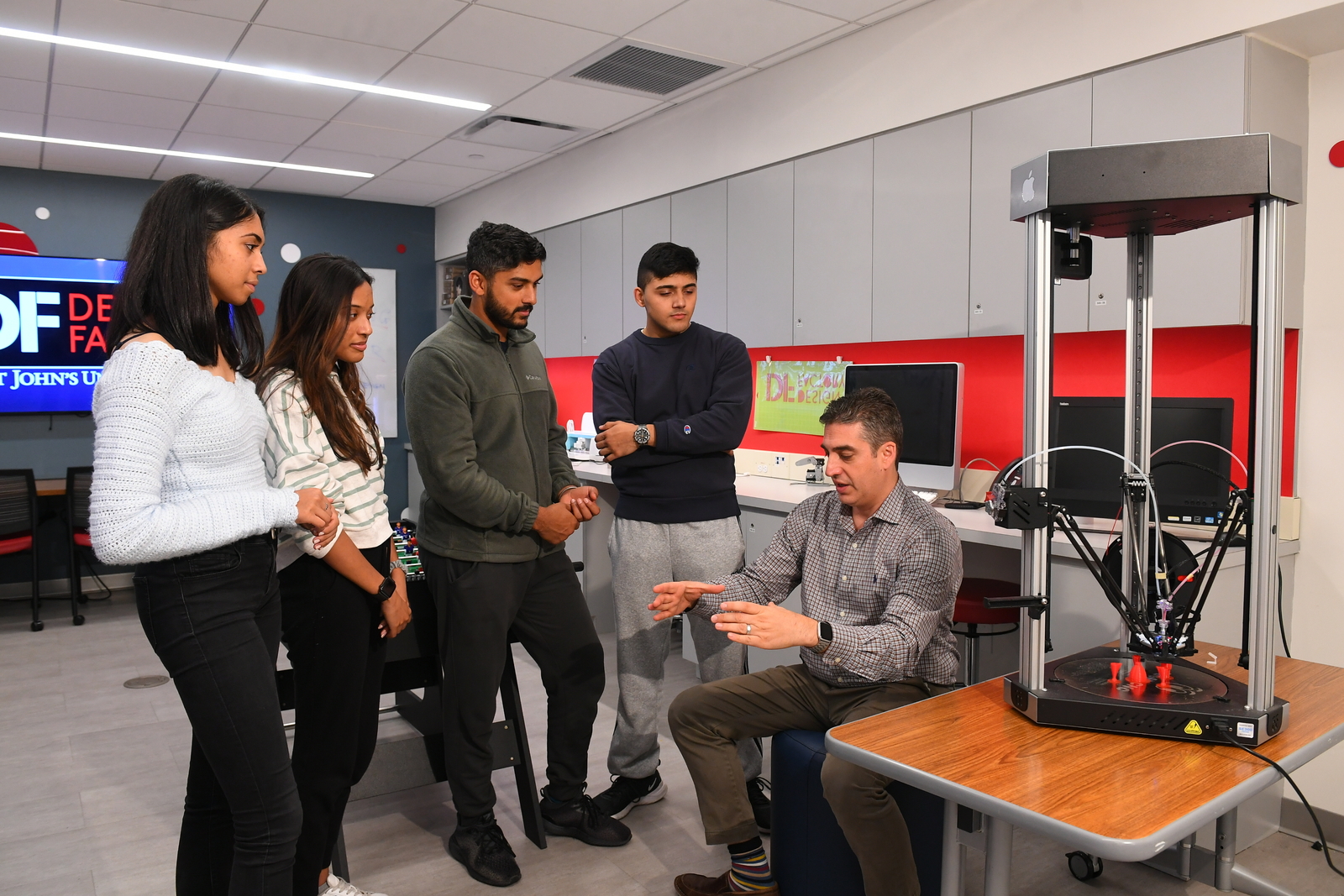 Students talking to a professor in the Design factory