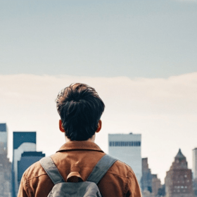 back view of male student looking at NYC skyline