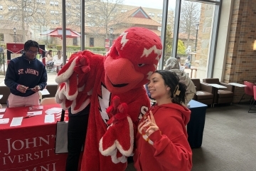 St. John's Mascot with student