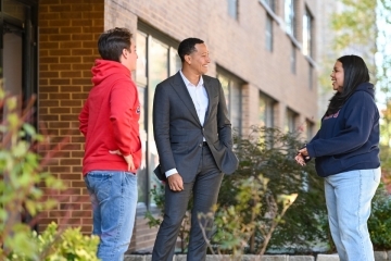 Students speaking to a faculty member