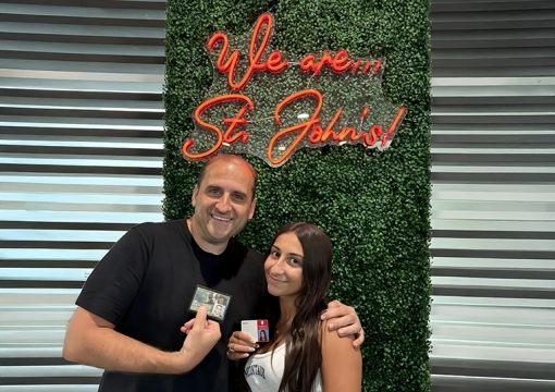 peter setaro, SJU Alumni, with his arm around his daughter