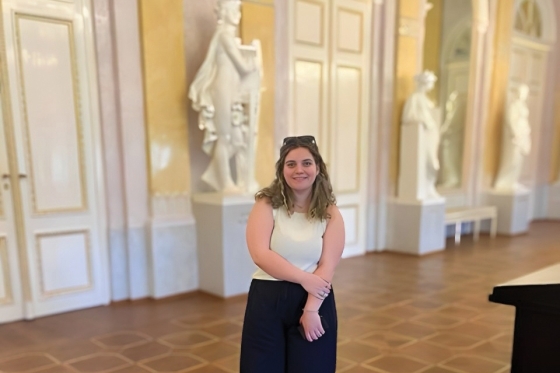 Alexandra McGill ’22C St Johns Alumna standing in hallway with statues