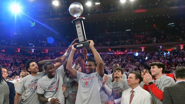 St. John's Men's Basketball holding up the BIG EAST Championship trophy at MSG