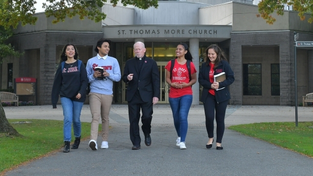 Father Shanley walking with students