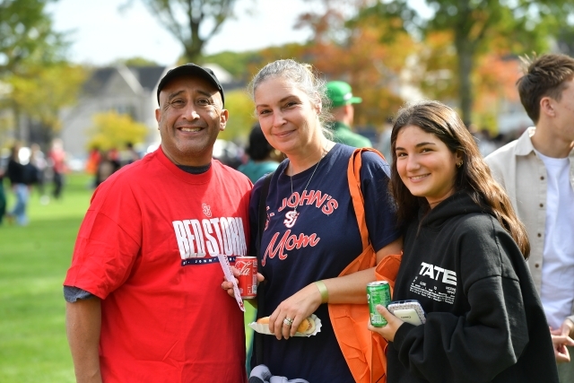 Three smiling people on the Great Lawn