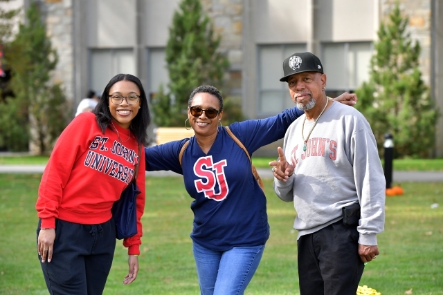 Three people on the Great Lawn in St. John's gear.