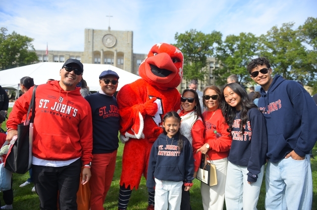 A large group taking a photo with Johnny Thunderbird on the Great Lawn