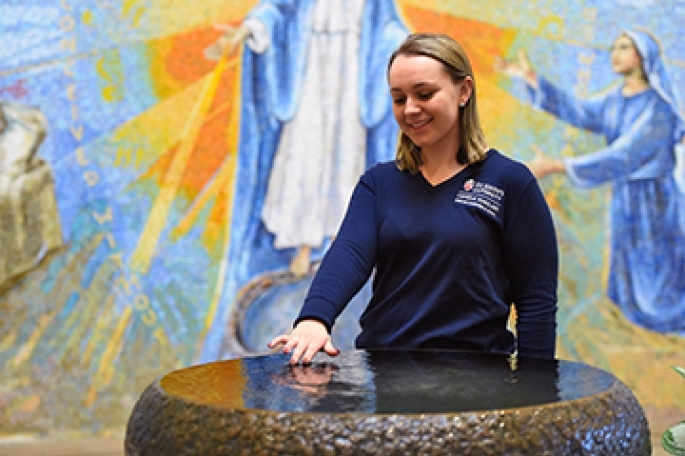 Student receiving holy water