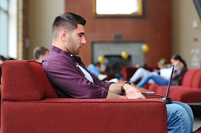 Student Typing on Laptop
