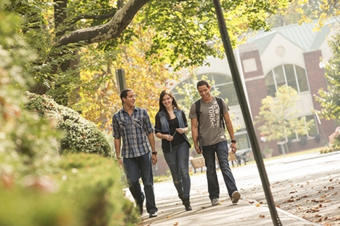 Three students walking on St. John’s Staten Island campus in Fall