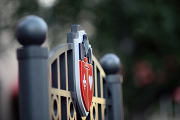 University Crest on the top of a sign