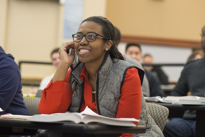 students sitting in a classroom looking at the front of the room