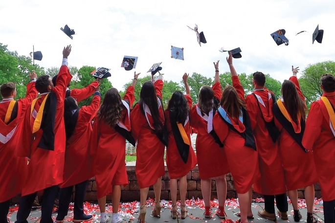 Students throwing caps at commencement