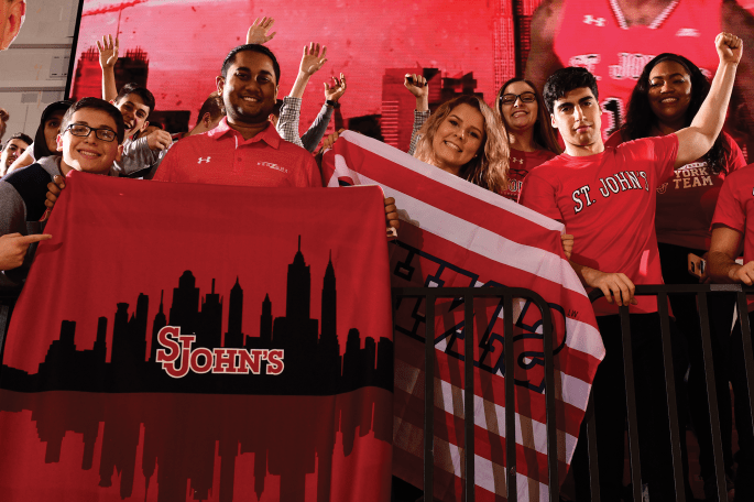 Students fans supporting Athletics with signage at a game