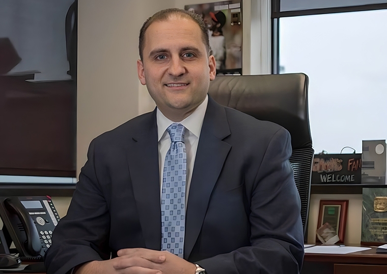 Peter Setaro, St. John's Alumni, sitting at his desk