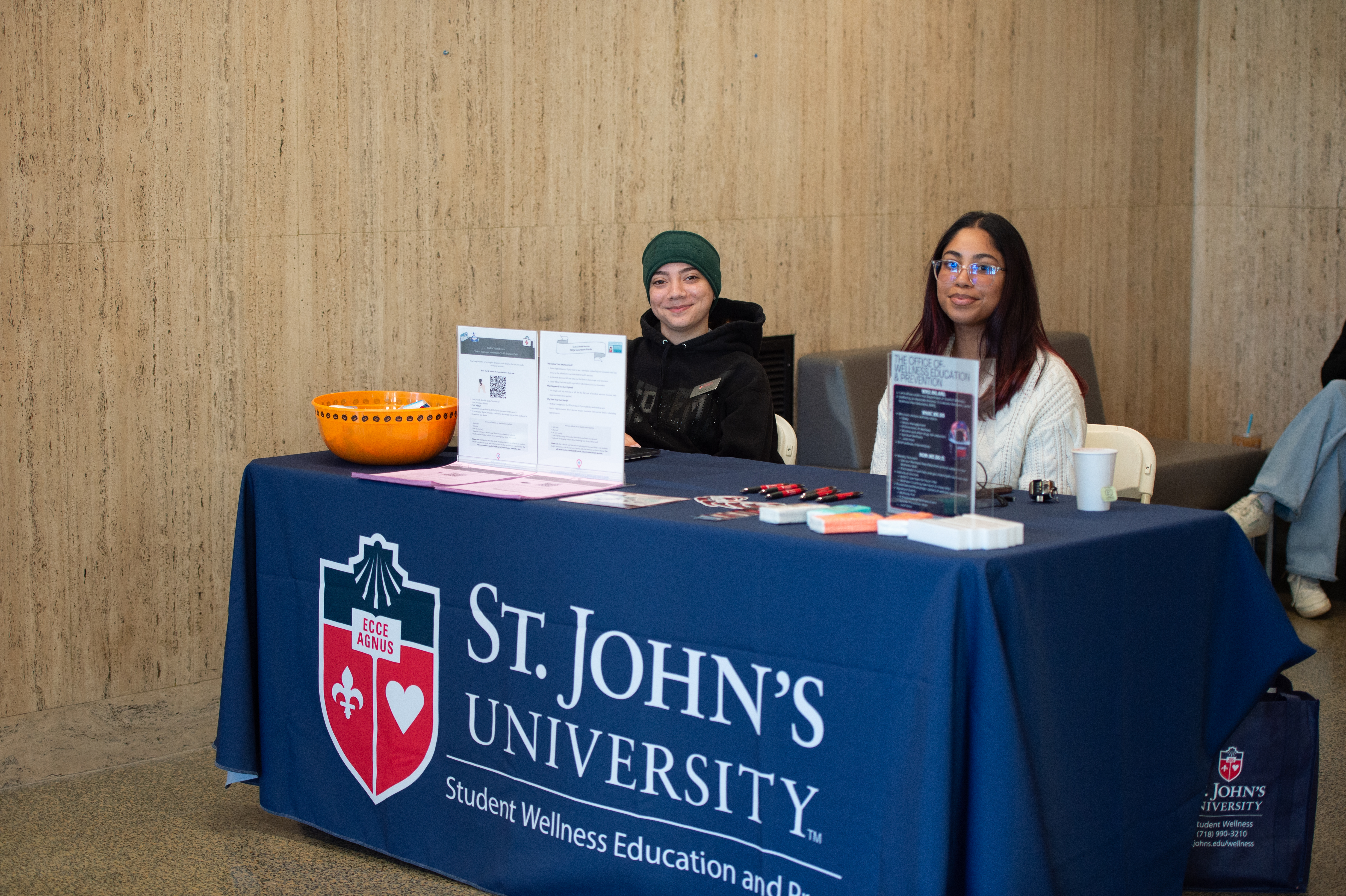 A table with two students representing St. John's University Health Services  