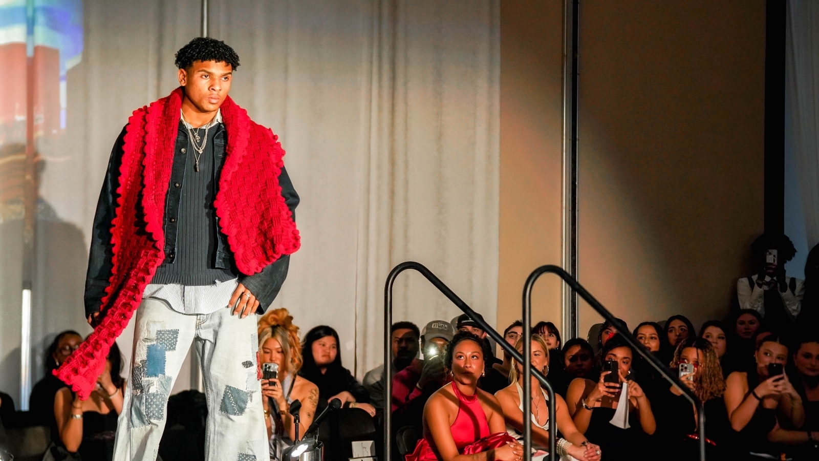 St. John's student walking down a runway for the annual fashion show