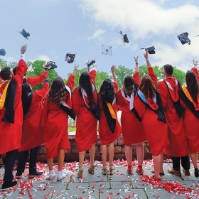 Graudates with back to camera caps in air