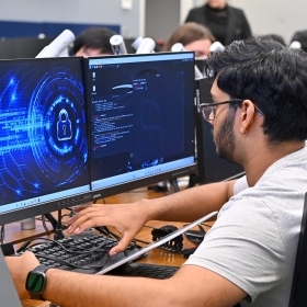 St. john's university cyber security grad student on a computer