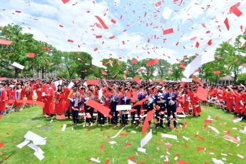 Confetti with graduates in the background