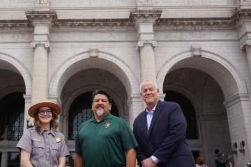 Elizabeth LaRochelle ’19C, ’20G standing with two gentleman outside a museum