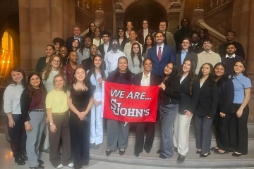 Students standing on a staircase.