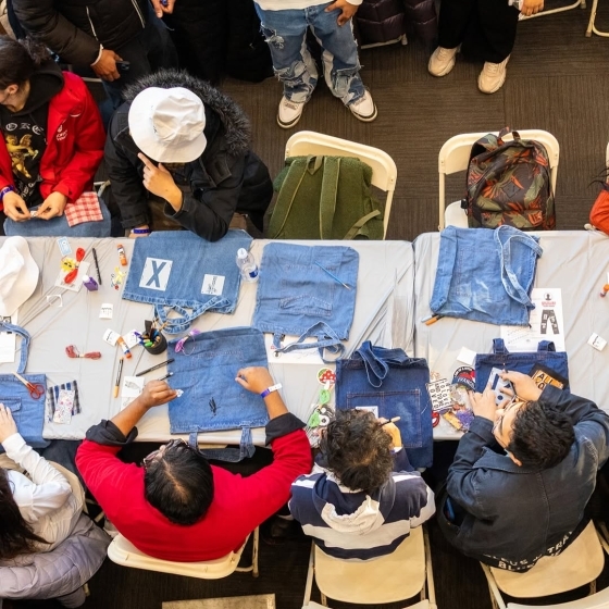 Student working on a jean stitching creative project