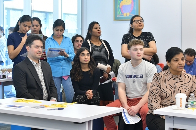 Students sitting at desks during St. John's VIC presentation 