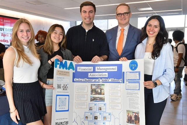 St. John's students holding poster for FMA with Dean 