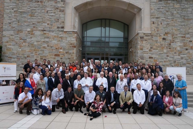 International Diploma of Social Doctrine of the Church summit attendees pose for a group photo in front of DAC