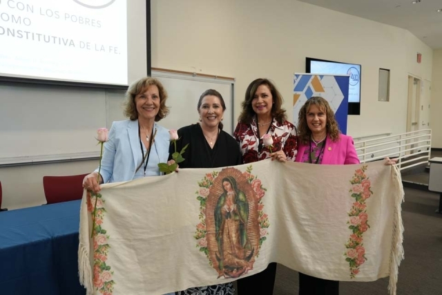 Inset of International Diploma of Social Doctrine of the Church summit attendees pose for a photo with fabric banner