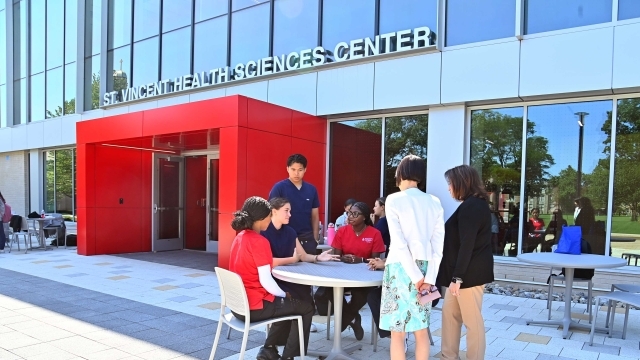 St. Vincent Health Sciences Center with faculty and students sitting at tables