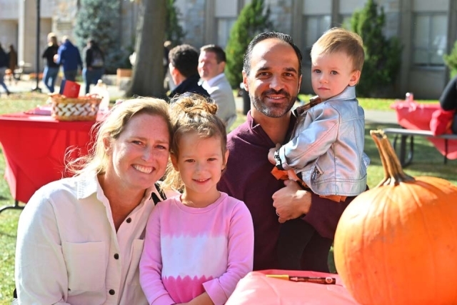 St. John's StormFest Alumni family enjoying pumpkin decorating 