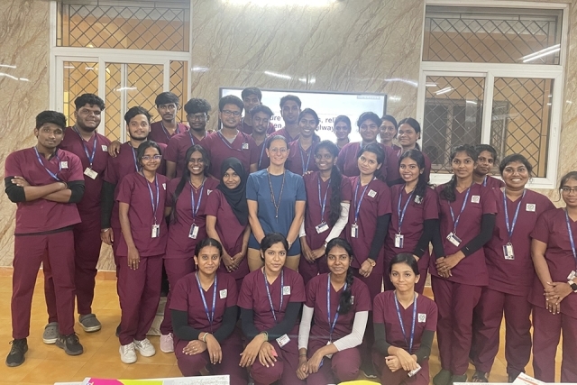 Dr. Ahmed with students posing for a group photo