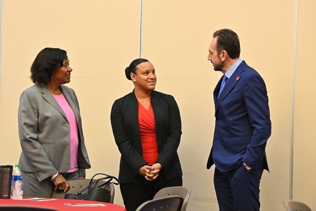 Dean Iandoli speaking with two women at FRC Faculty Research Luncheon