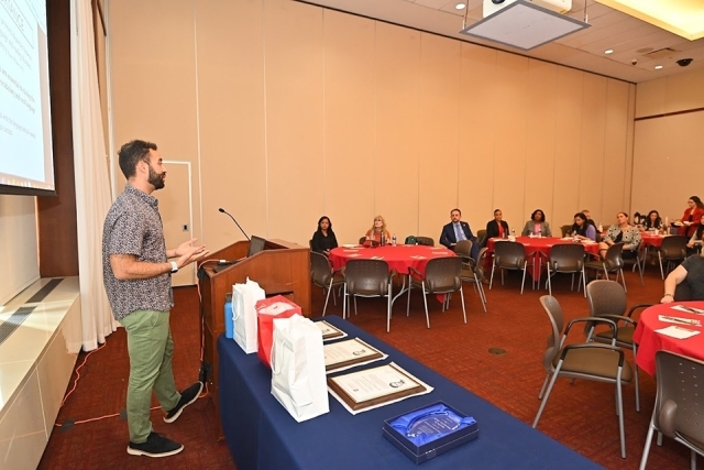 Max Freeman speaking at podium