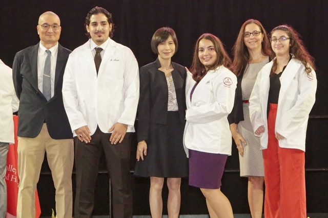 St. John’s University’s College of Pharmacy and Health Sciences received their white coats from Dean Lin