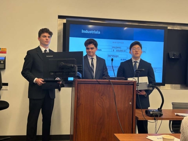 three Tobin students presenting at podium 