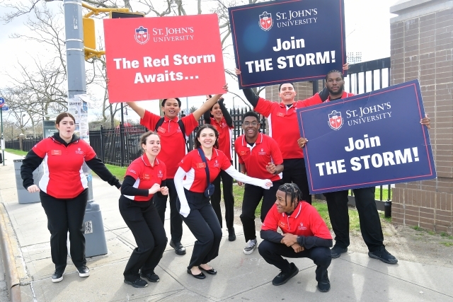 Student ambassadors holding signs on accepted student day 