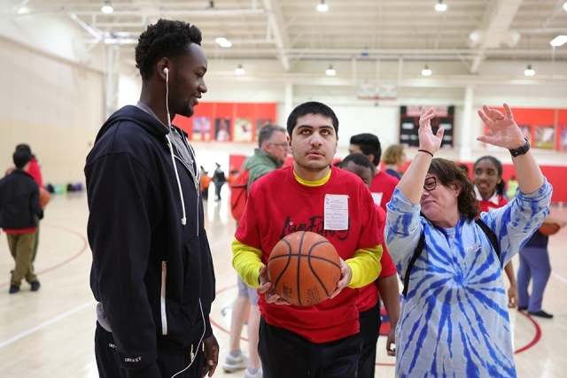 St. John's athlete with special needs students playing basketball
