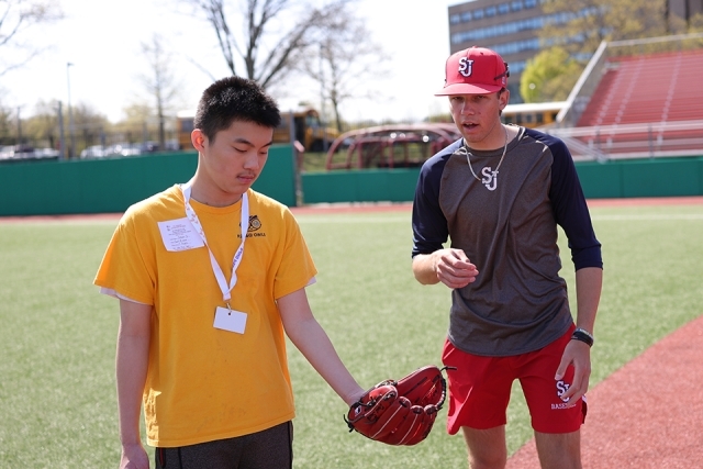 St. John's athlete with special needs student using a baseball glove