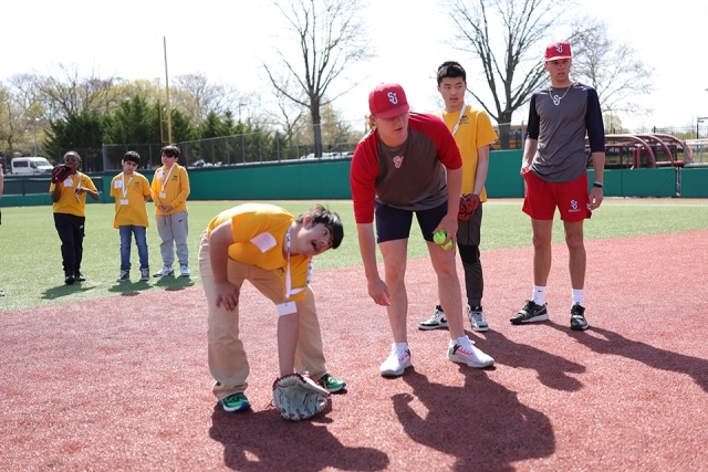 St. John's athletes with special needs students on the baseball field