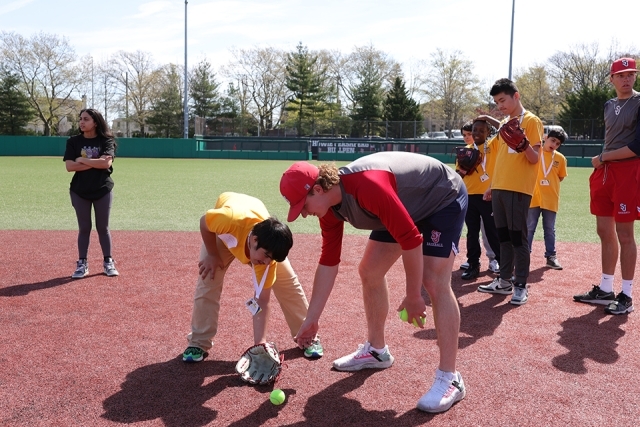 St. John's athletes with special needs students on the baseball field