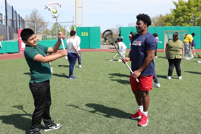 St. John's athletes with special needs students on the lacrosse field