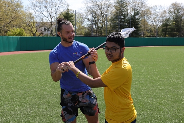 St. John's athlete with special needs student on the lacrosse field