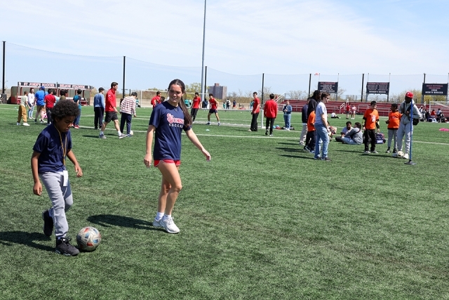 Special needs students playing soccer with St. John's athletes