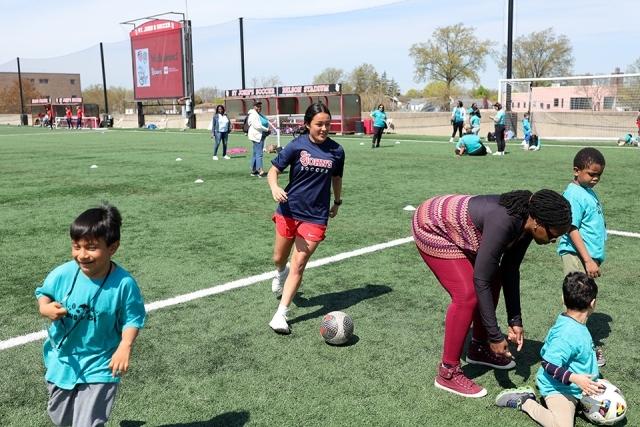 Special needs students playing soccer with St. John's athletes