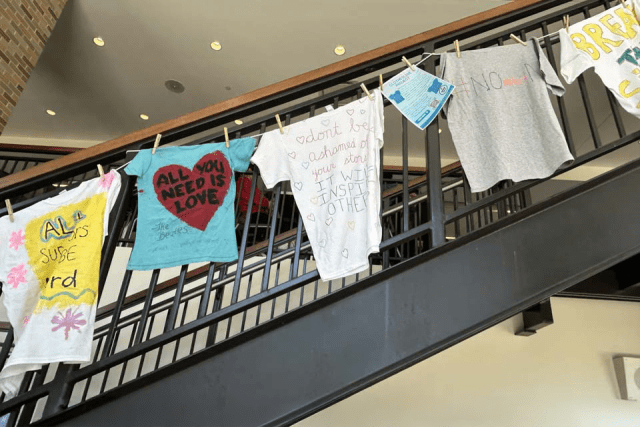 SOAR T-shirts hanging from D'Angelo staircase
