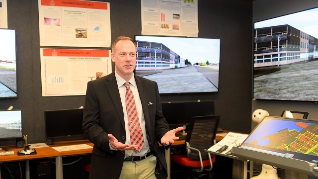Man standing and speaking in the Homeland Security lab