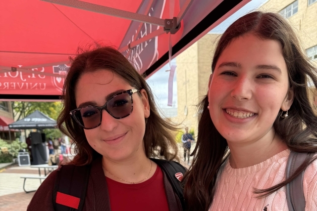 St. John's students holding Thank You signs for our donors generous donations
